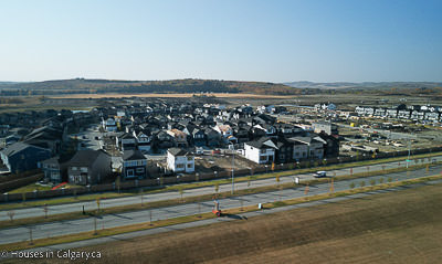 looking south from the air a view Pine Creek Homes for Sale. There is a small hill and a blue sky in thee background 