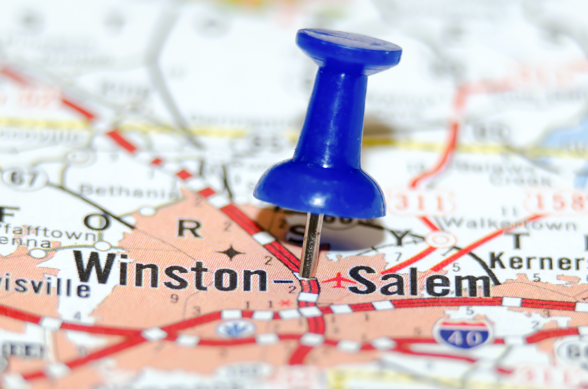 A picture of Winston-Salem, NC on a roadmap with a push pin in the middle.