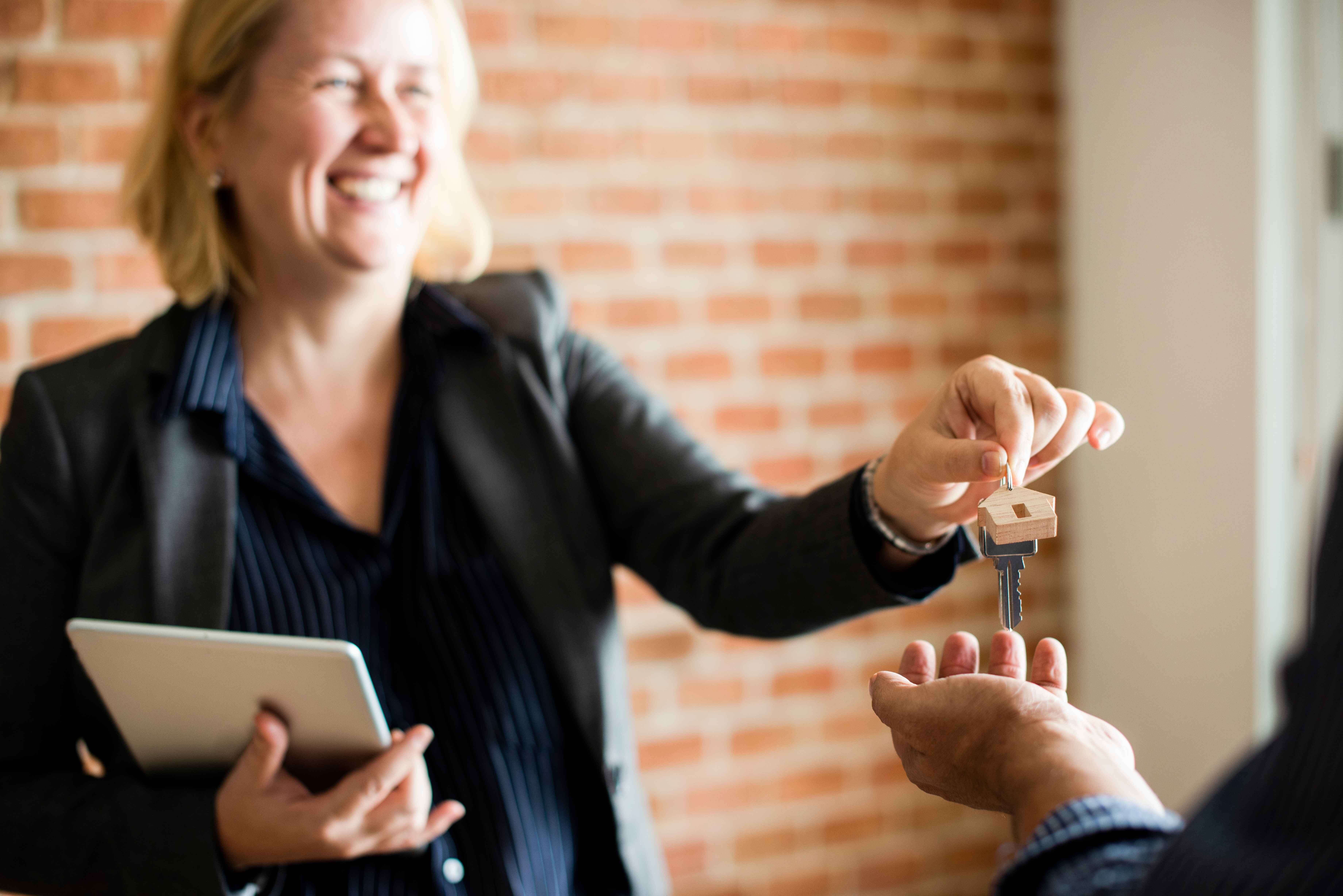 real estate agent handing buyer the key