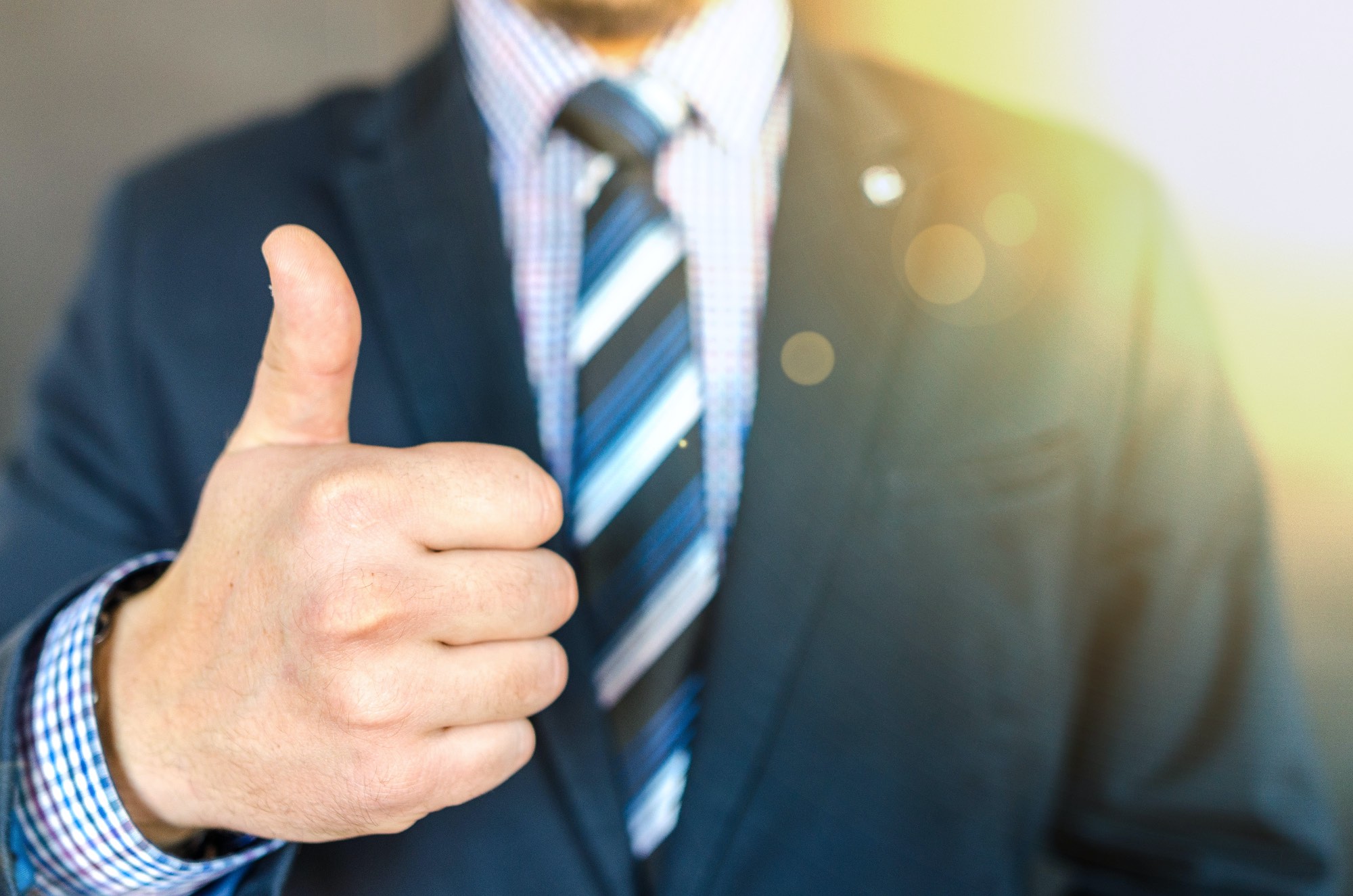 close-up-photo-of-man-wearing-black-suit-jacket-doing-thumbs-up