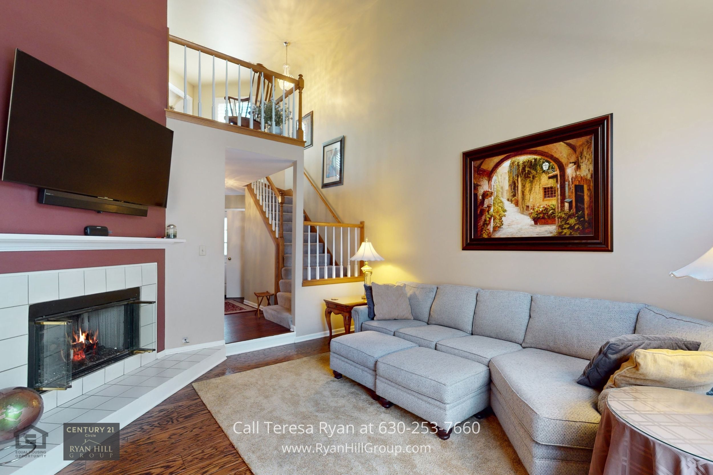 Cozy living room located at the main level of a Winfield IL townhome with a gas fireplace and double sliding doors.