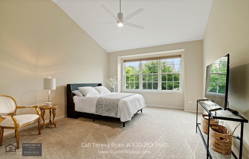 The main level master suite of this Aurora IL luxury home offers relaxation and comfort.
