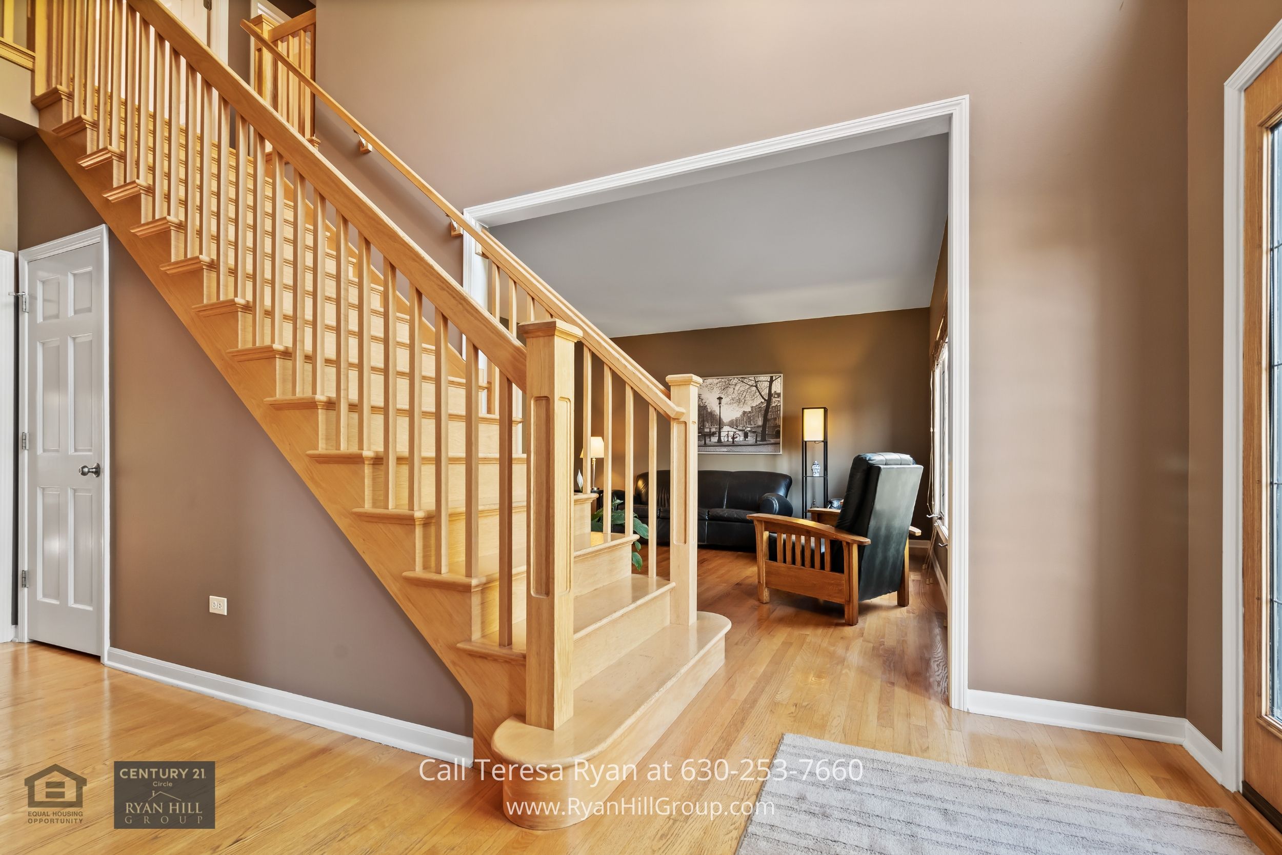 a living room with a stair case next to a couch