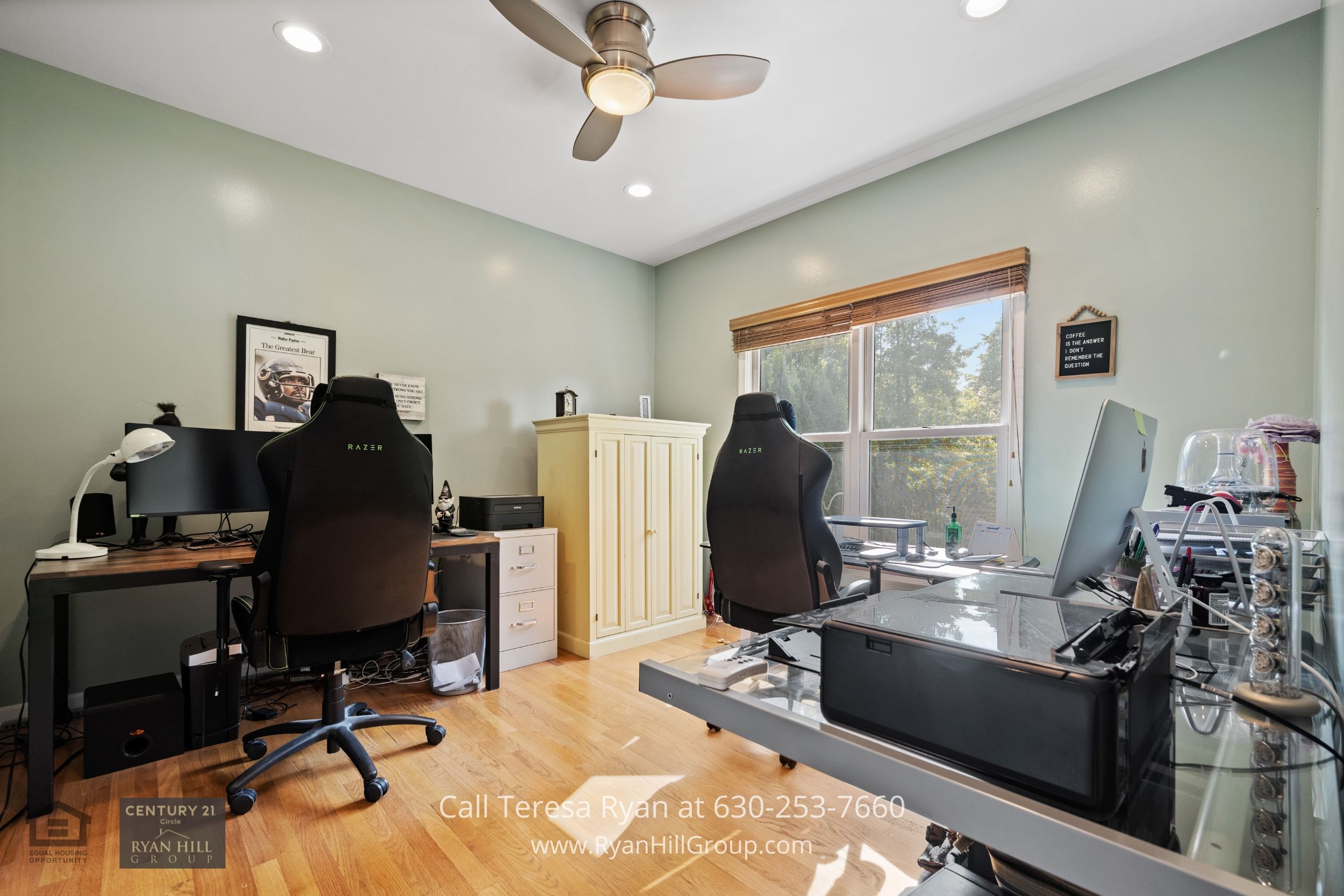 a home office with a computer desk and a laptop