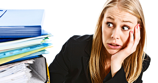 Woman overwhelmed by paperwork