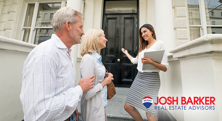 A real estate agent showing a house to a couple