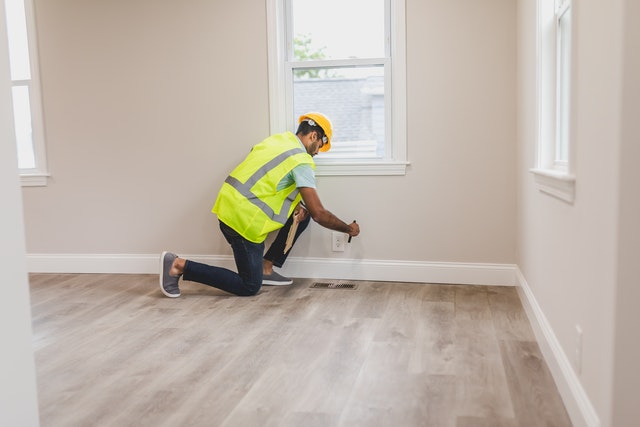 a man making repairs inside a house