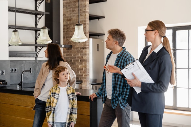 a real estate agent showing a house to a family