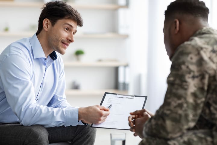 Lender talking with a military man in uniform.