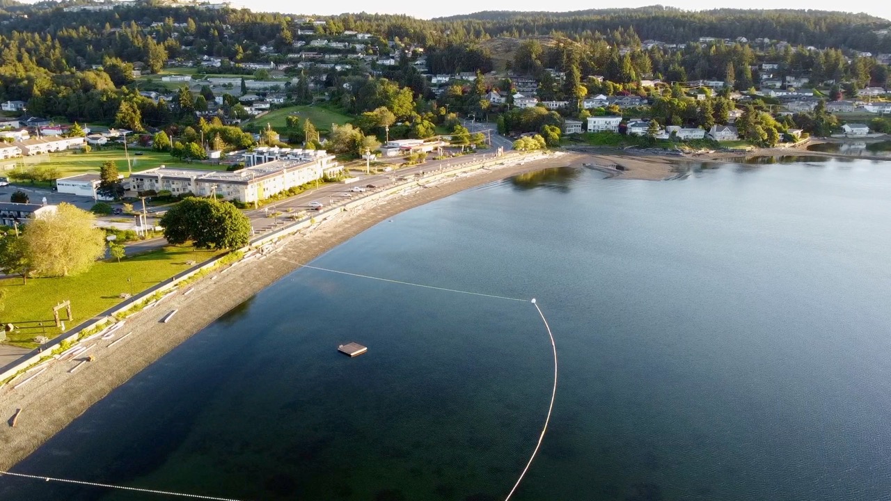 Aerial view of Departure Bay Beach swimming area at sun rise