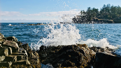 Wave crashing on the shore of Pipers Lagoon in Nanaimo