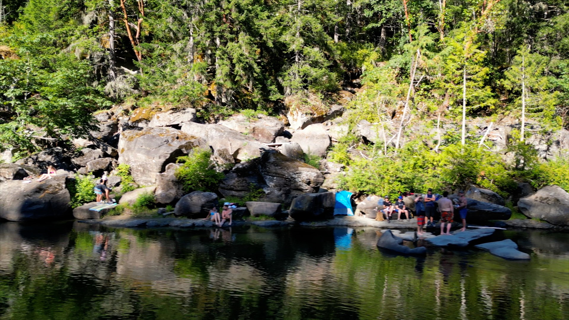 Calm waters and people swimming next to the Nanaimo River