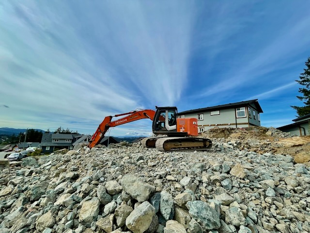 Excavator digging rocks on a construction site