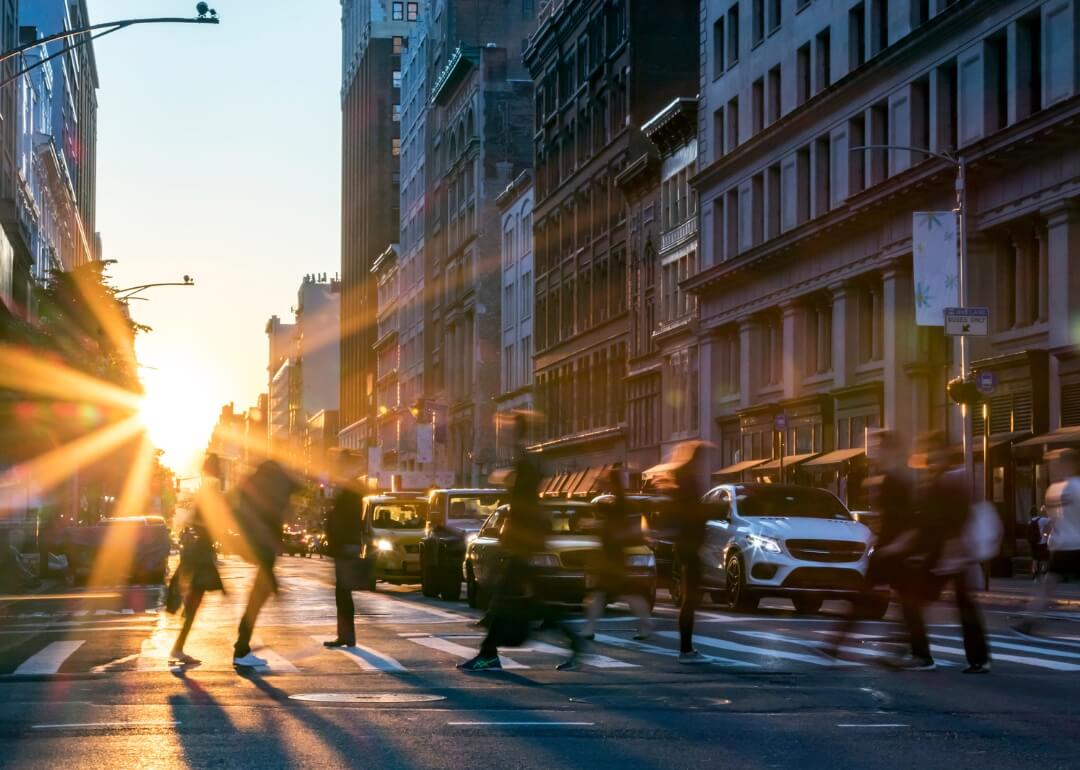 Blurry people moving quickly through a crosswalk in New York City