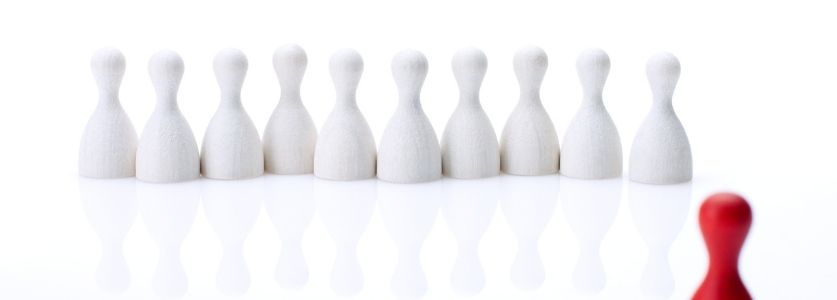 White bowling pins with one red 