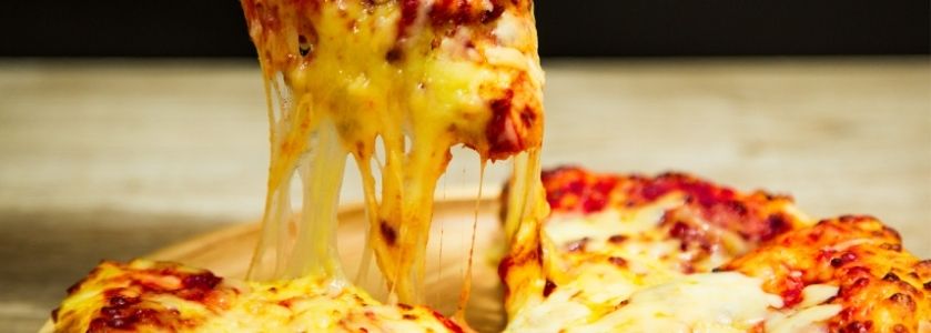 close up of stretchy cheese pizza