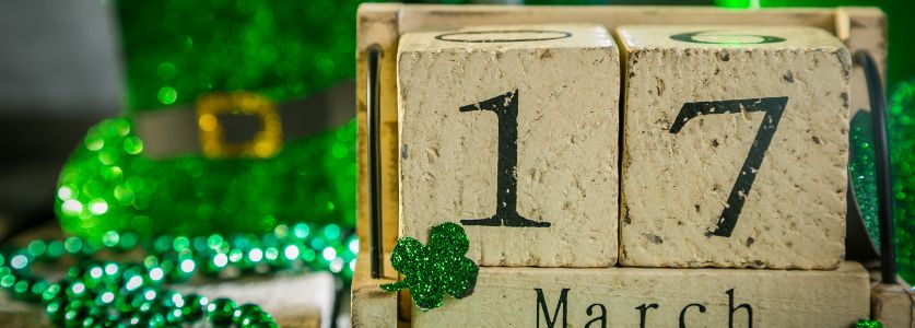 st patricks day date in wooden blocks on colorful green table