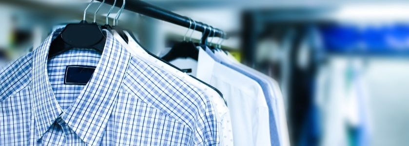 dry cleaned shirts hanging on rack