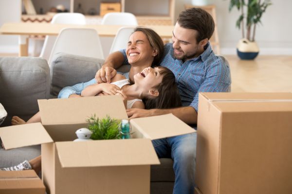 first time home buyers in new home first time home buyers smiling and laughing in new home