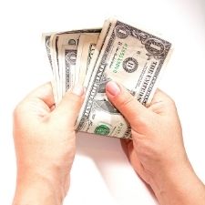 hands counting dollar bills