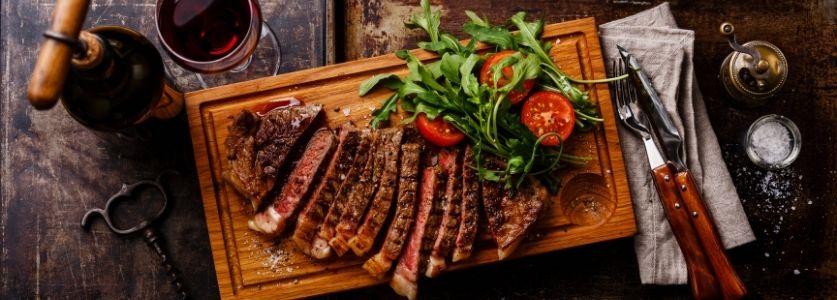 steak on wood fire slab