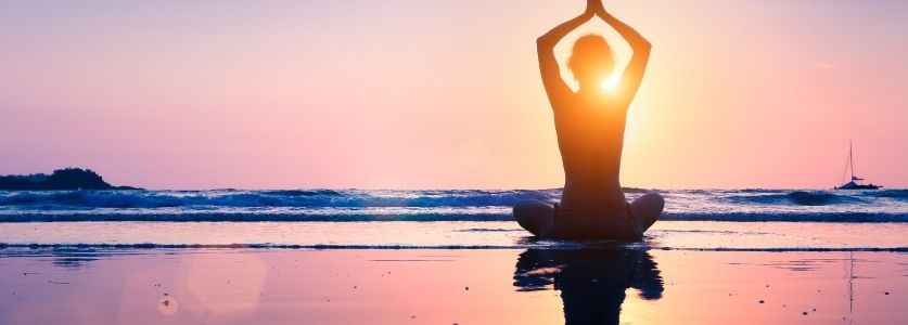 yoga pose on sunny beach