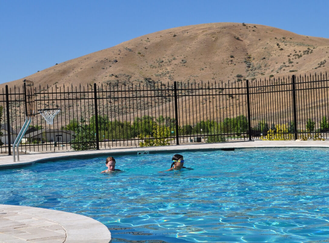 kids swimming in a pool near the Bosie foothills. Photo by Build Idaho