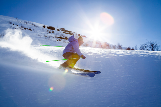 Image of skier swoosing down the slopes at Park City Mountain Resort