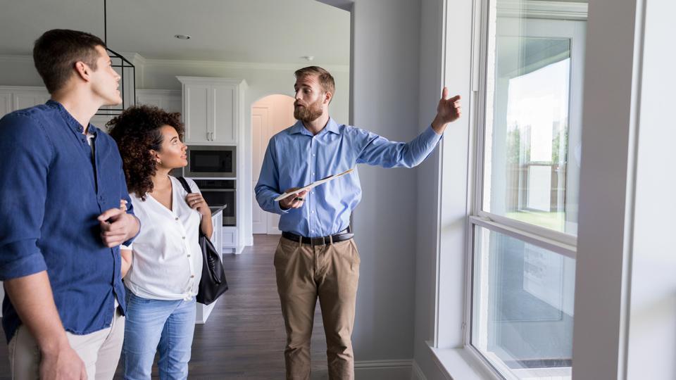 Agent showing a home to a couple