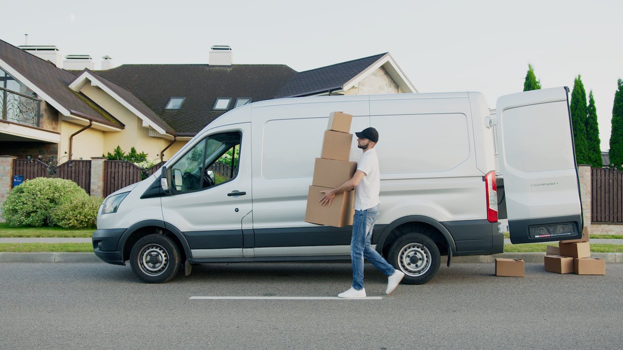 A mover taking boxes out of the van.