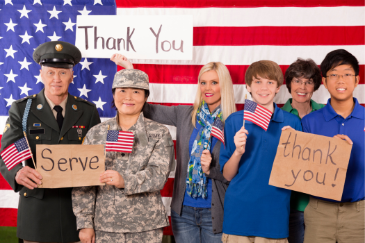 children_and_teacher_holding_thank_you_signs_for_military_veterans