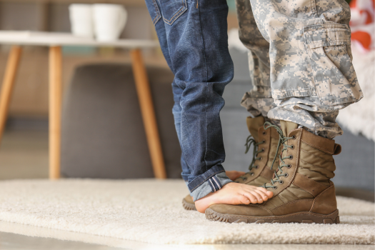 small_child_standing_on_military_parents_boots