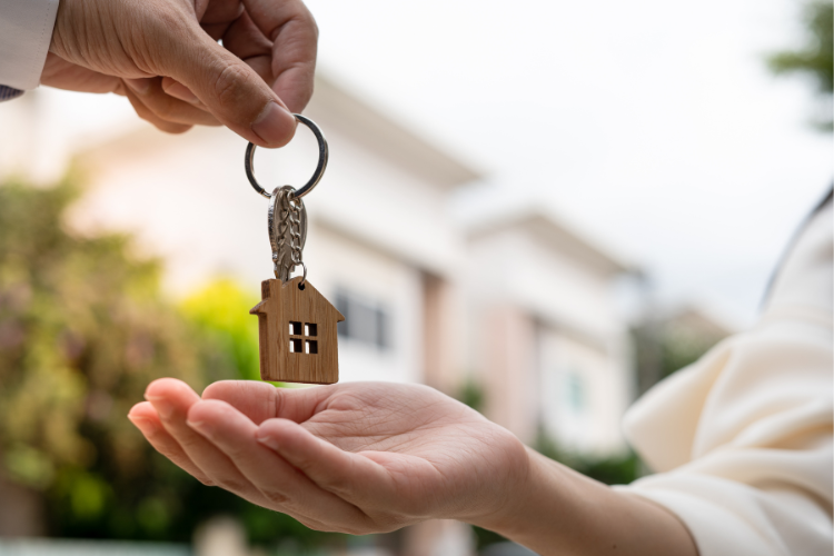 realtor handing keys to new home over to new homeowner