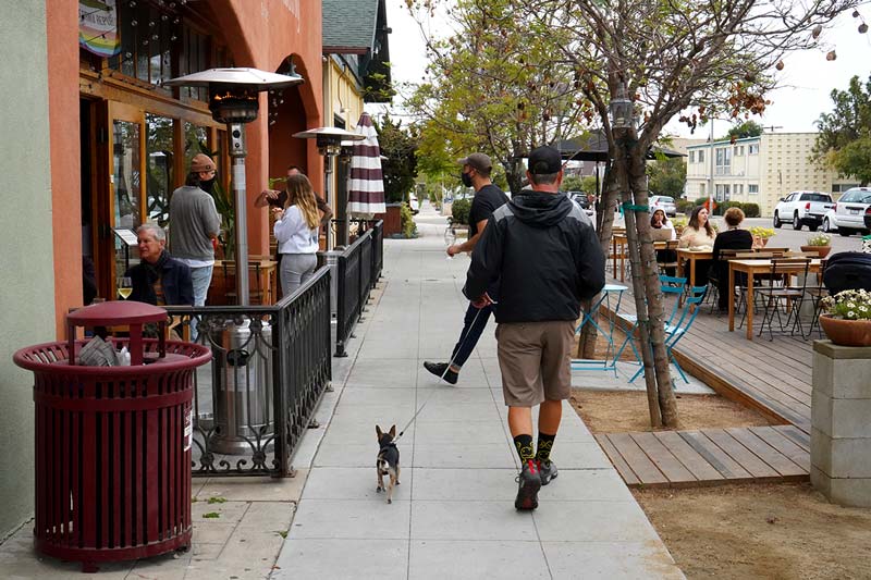 man with dog walking in south park san diego