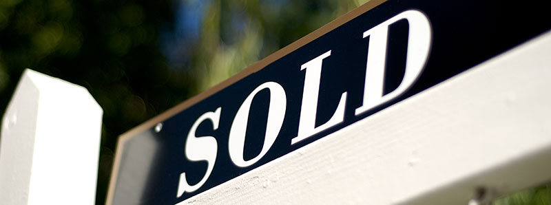 sold sign in front of house