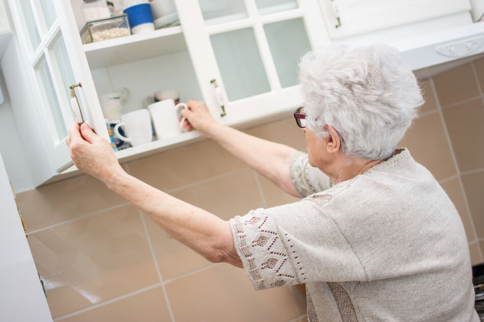 Senior Using Kitchen Cabinets