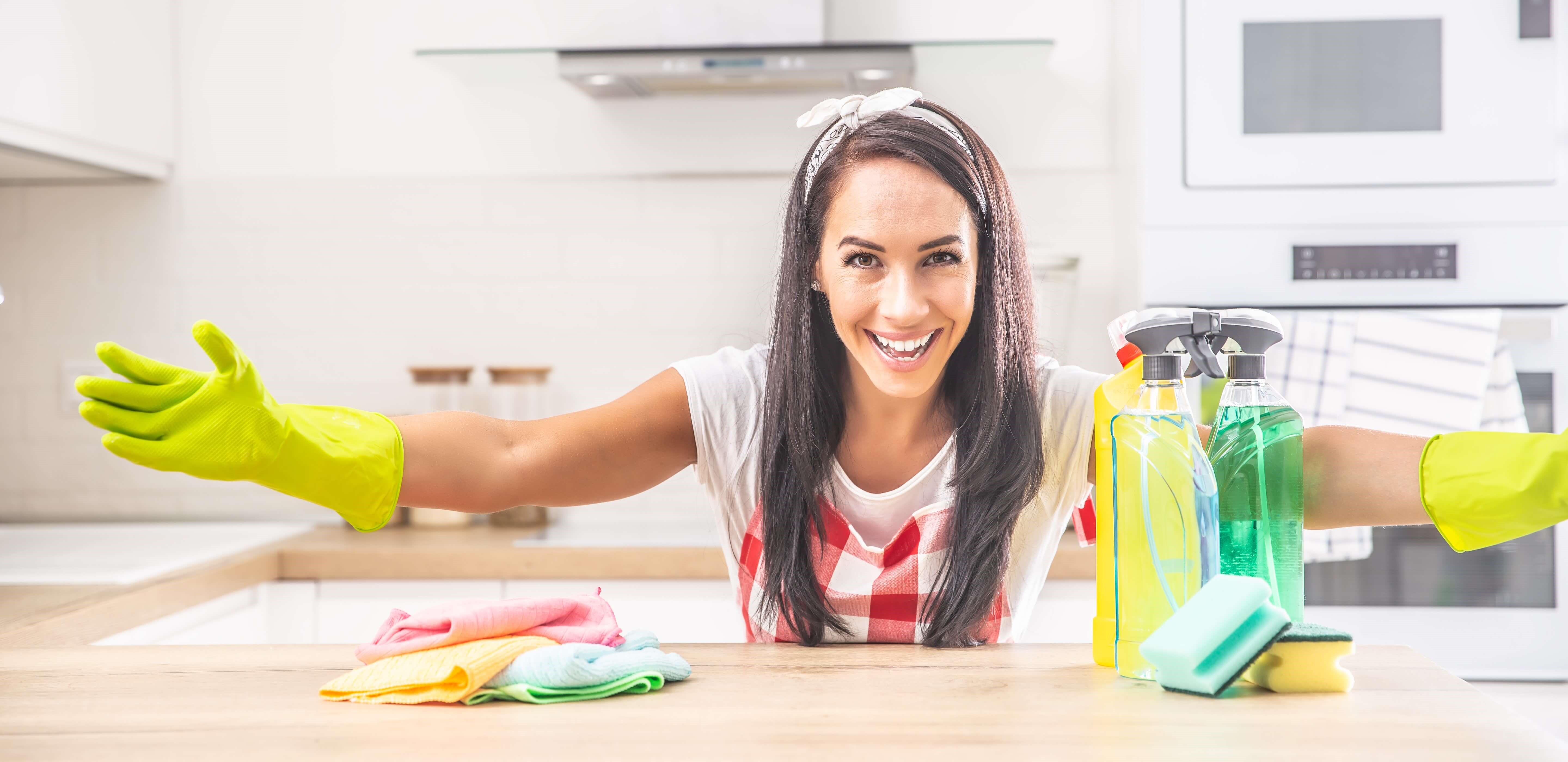 woman poses while cleaning home