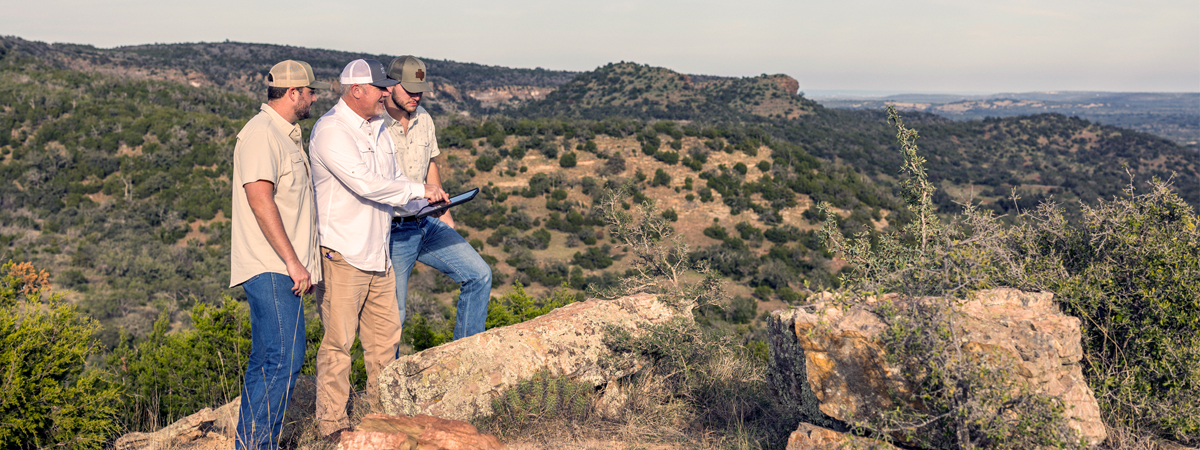 Article for 7 Reasons Why You Should Sell Your Ranch in Texas With a Ranch Real Estate Agent showcasing the team looking over areas of a ranch.