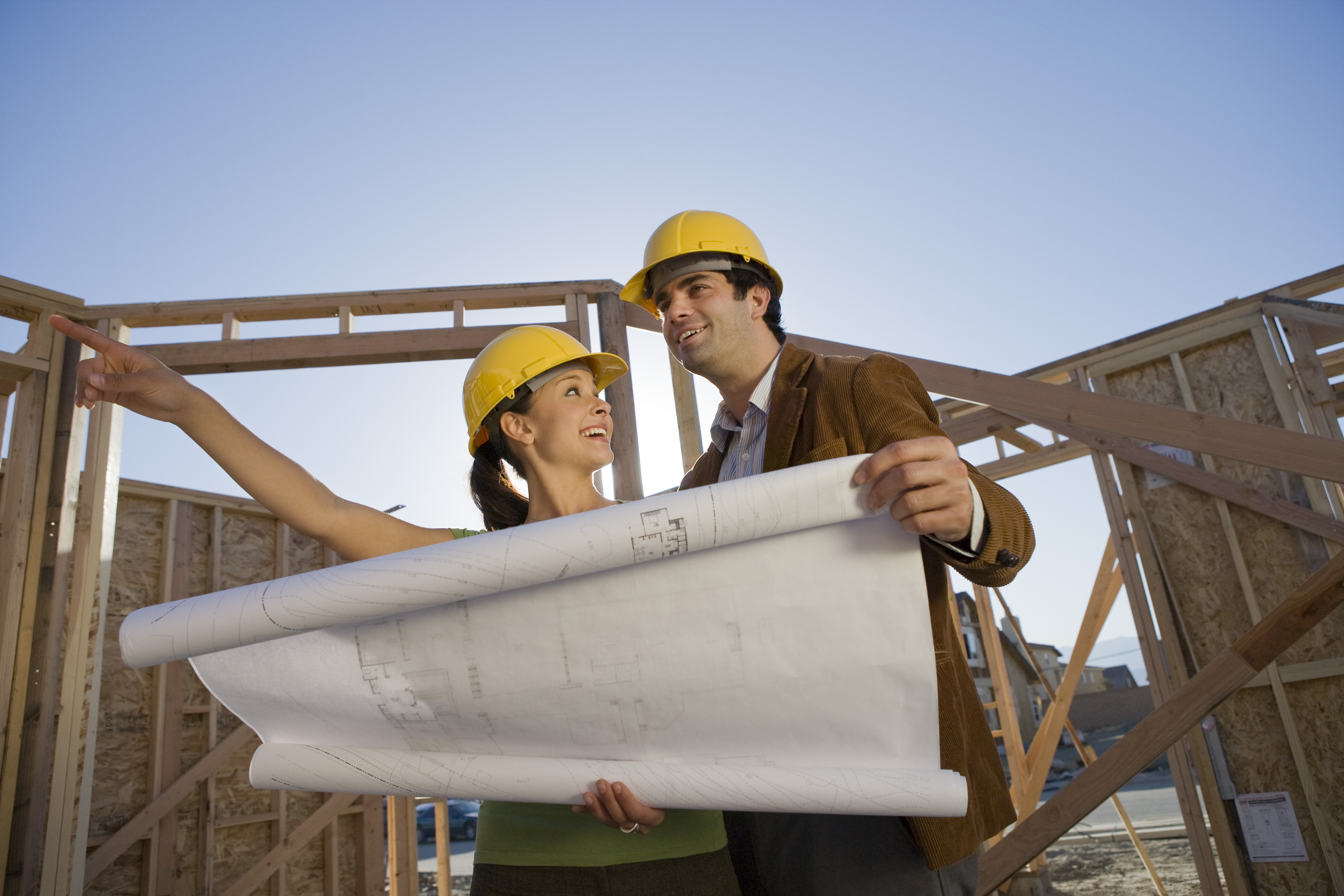 couple looking at blue print of new house build