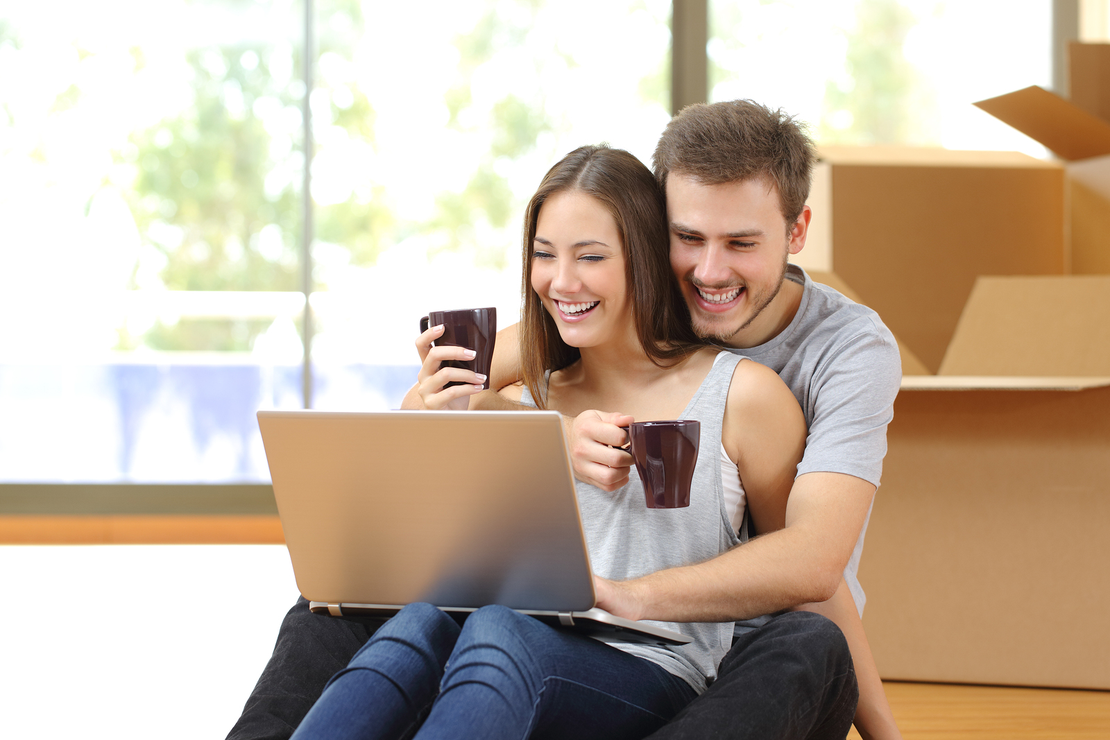 couple looking at computer to find a home