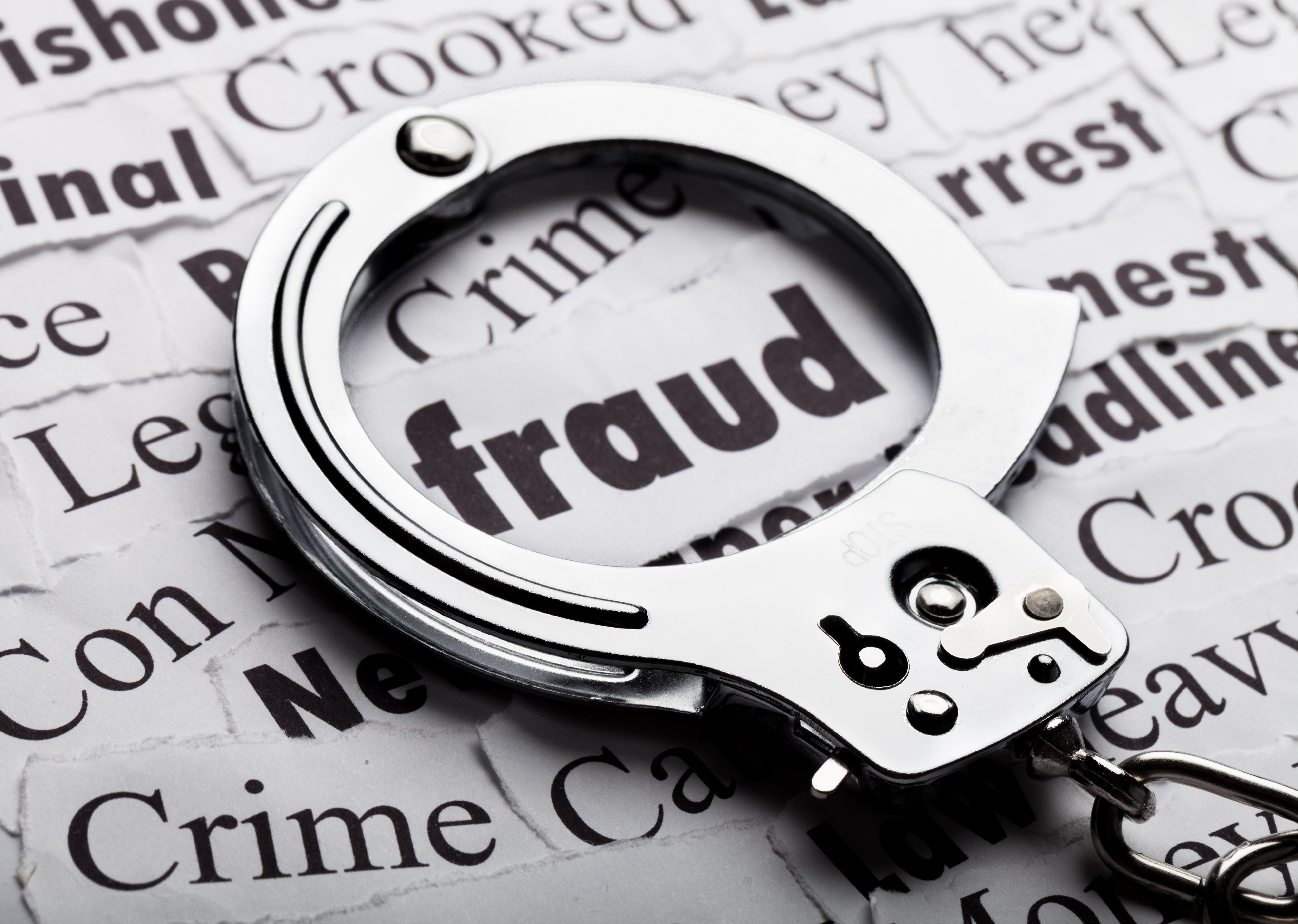 handcuffs around the word fraud