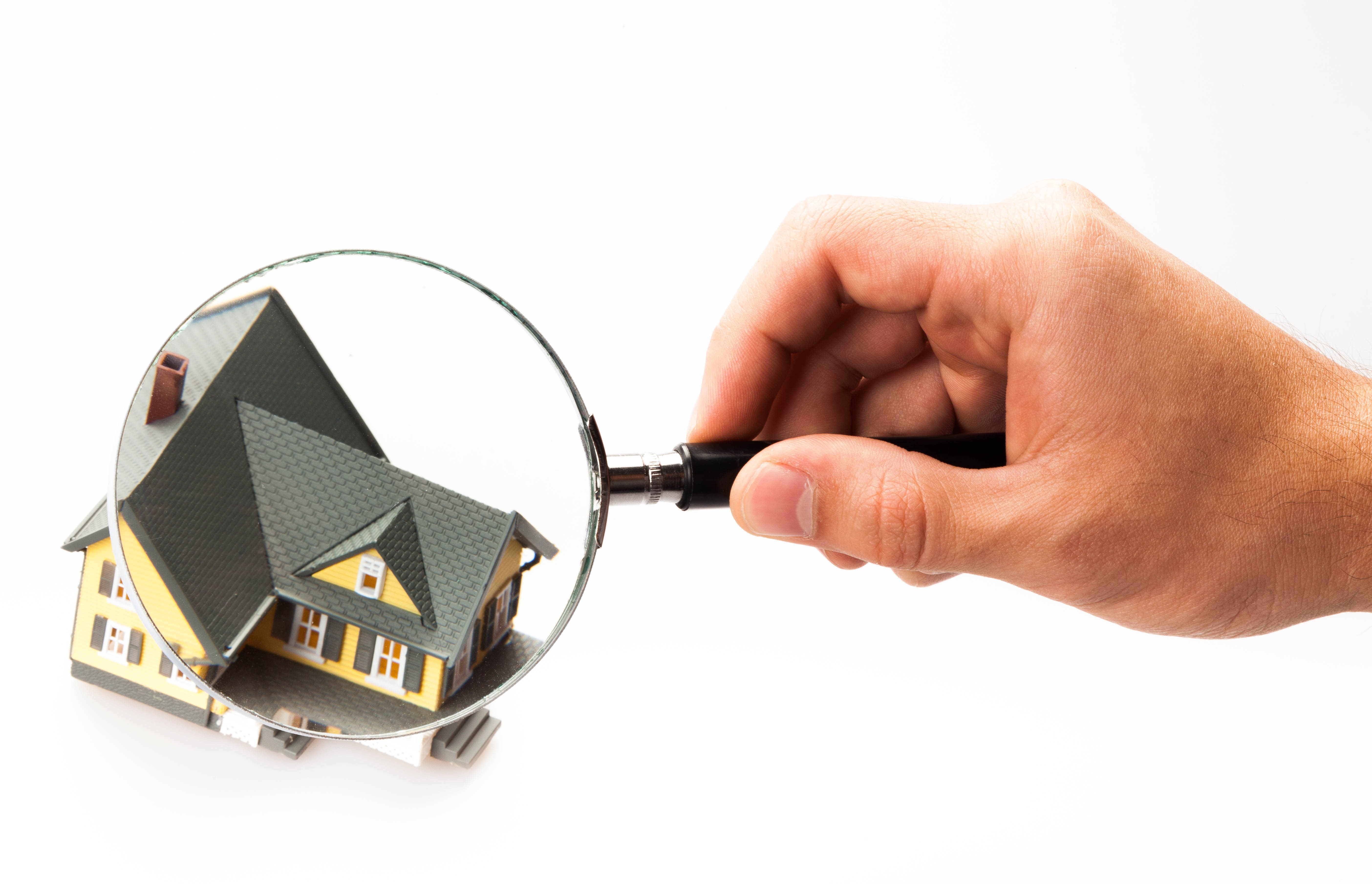 magnifying glass looking at house