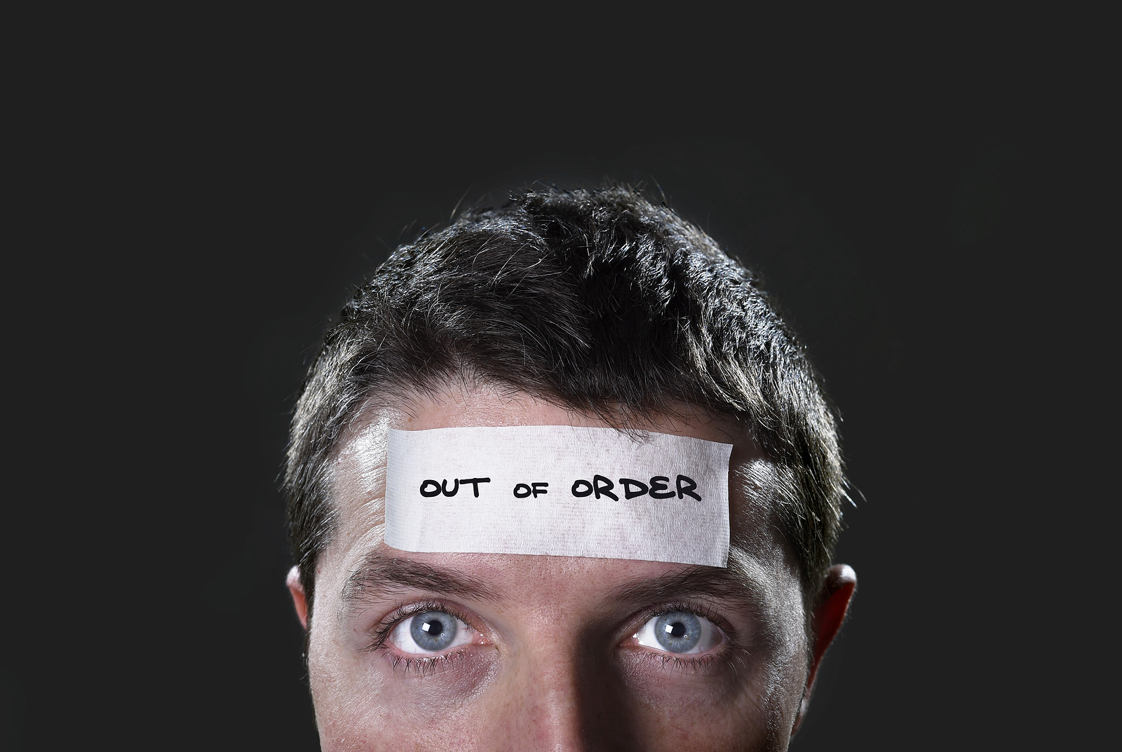 man with out of order sticker on head to show lack of communication for real estate deal