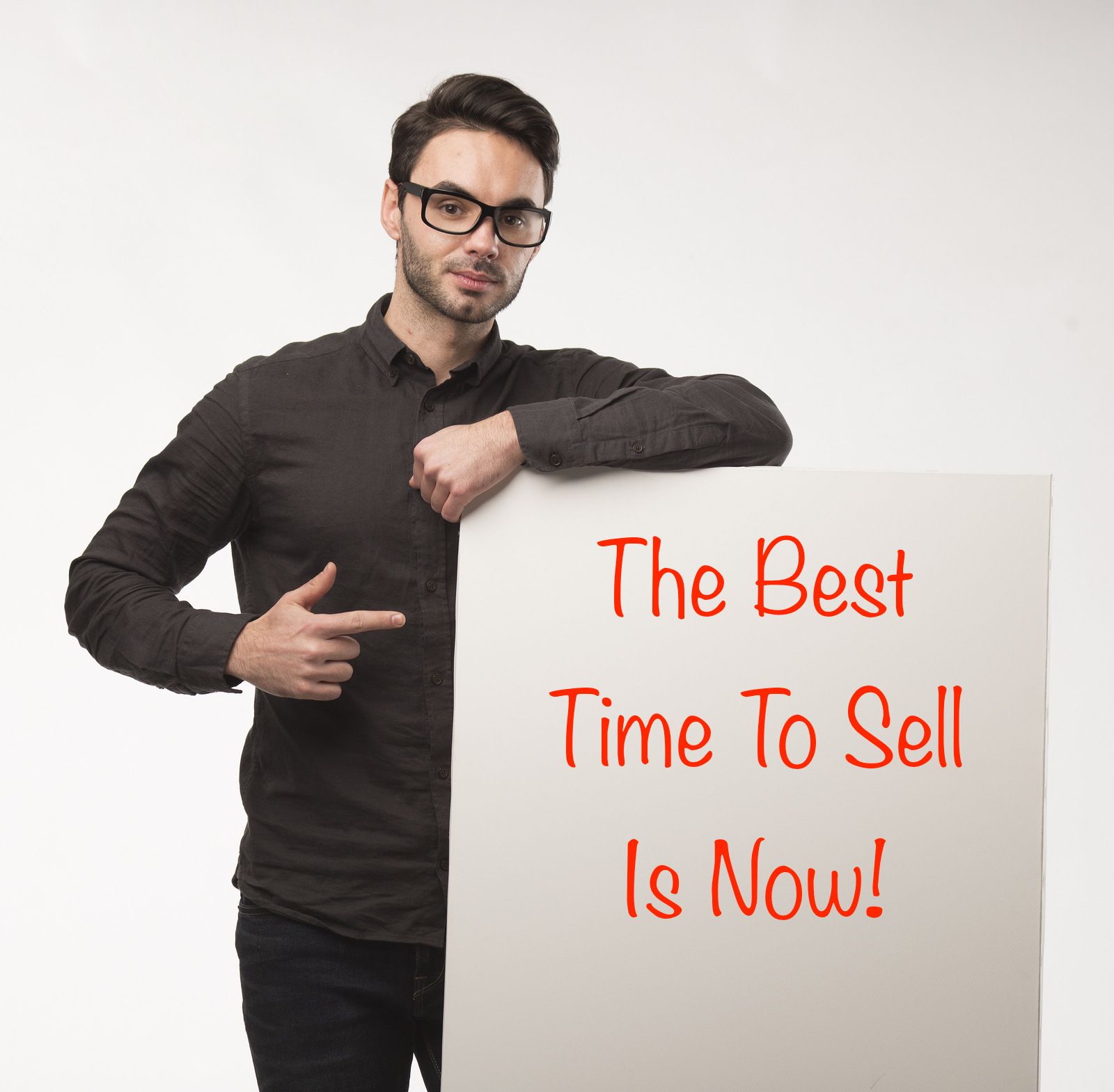 man with sign that says the best time to sell is now