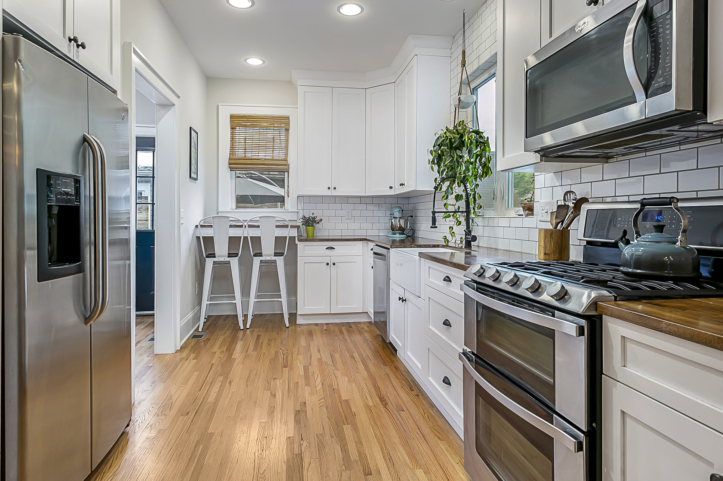 429 Pecan Ave, Charlotte, NC 28204 Kitchen Gallery style kitchen with white cabinets and stainless steel appliances