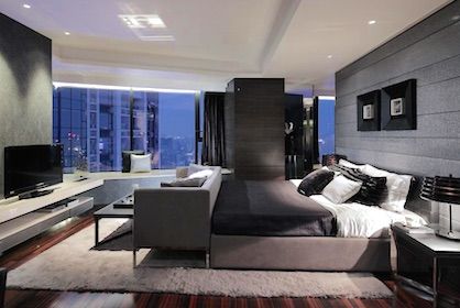 Bedroom in a luxury high-rise condo with amazing city views.