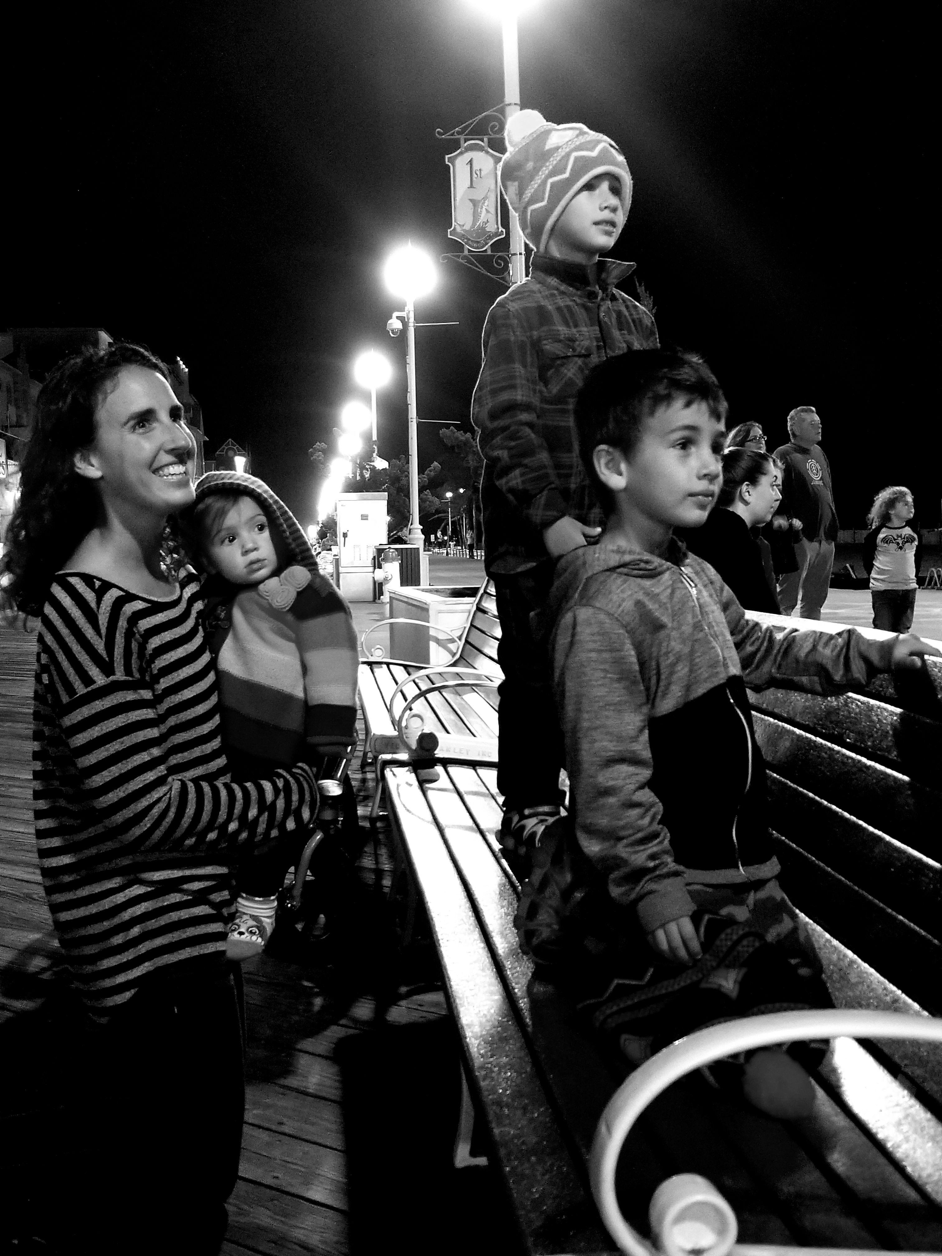 A family watching fireworks on the Ocean City, MD boardwalk.