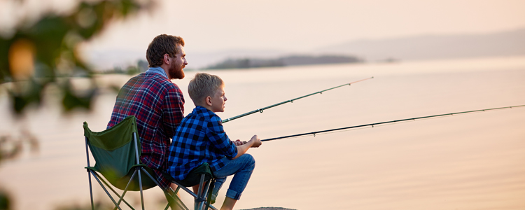 Father and Son Fishing While Camping