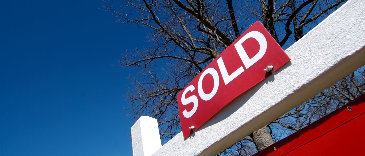 Picture of a sold sign in front of a house