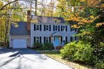 An example of a home for sale in Brandermill, two story, one car garage, with a light blue door.
